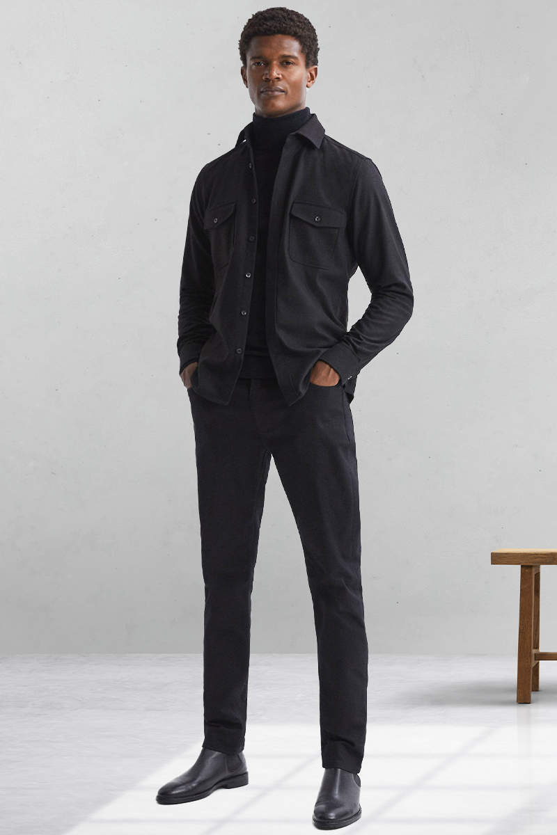 All-black outfit with overshirt, turtleneck, jeans, and Chelsea boots