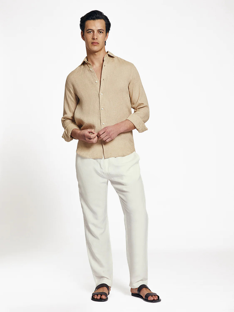 Beige linen shirt, white chinos, and black sandals outfit