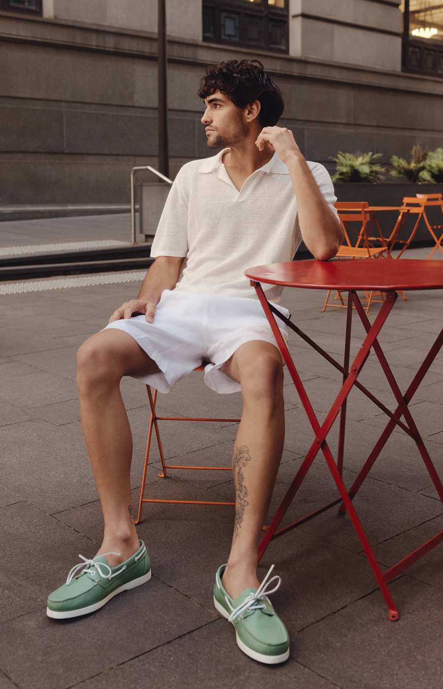 Beige linen shirt, white shorts, and green boat shoes outfit