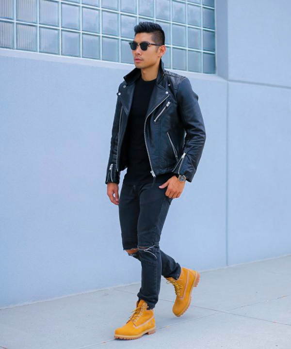 Black leather biker jacket, black crew neck shirt, ripped black jeans, tan timberland boots outfit