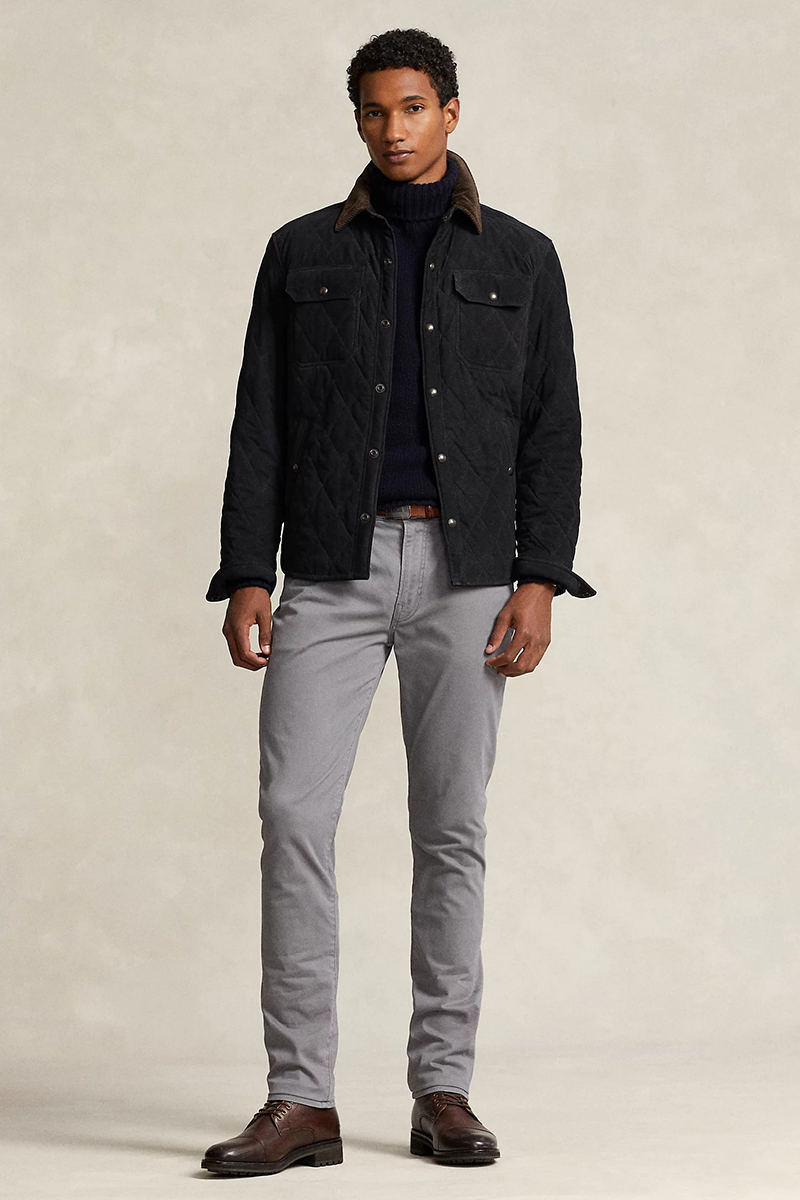 Black quilted jacket, navy turtleneck, grey chinos, and dark brown lace-up boots outfit