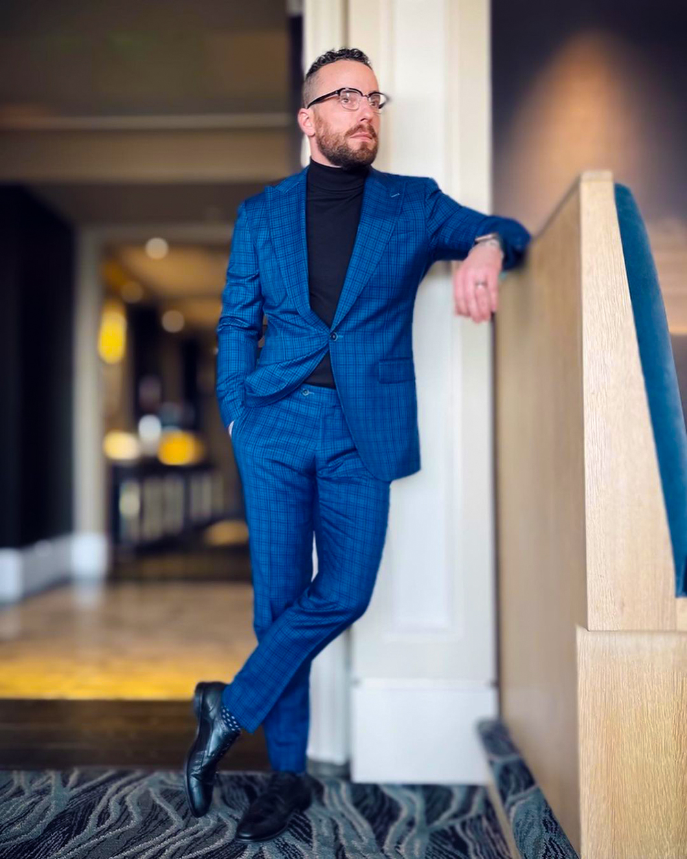 Blue suit with black turtleneck and derby shoes outfit
