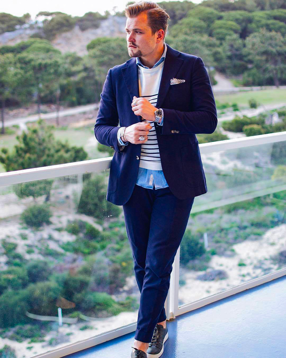 Blue suit with crew neck sweater, long sleeve shirt, and sneakers outfit