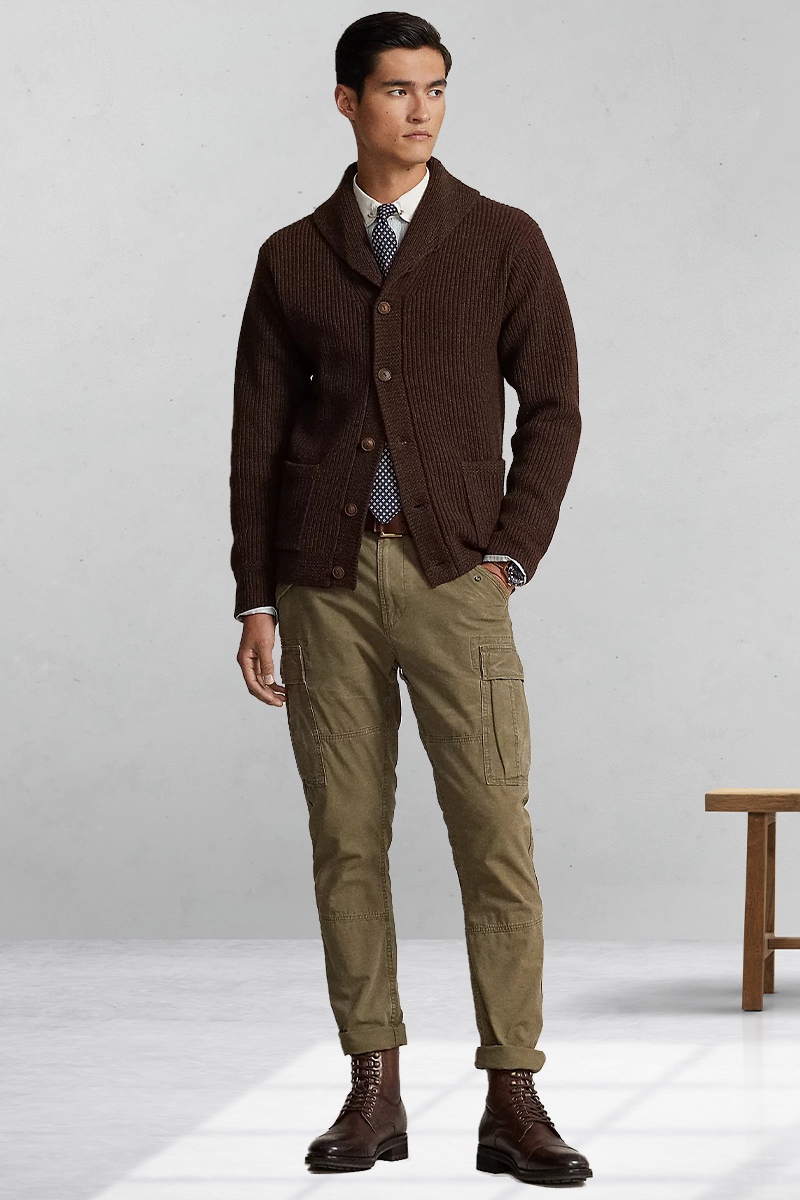 Brown cardigan, light blue dress shirt, blue dotted tie, green cargo pants, and brown lace-up boots outfit