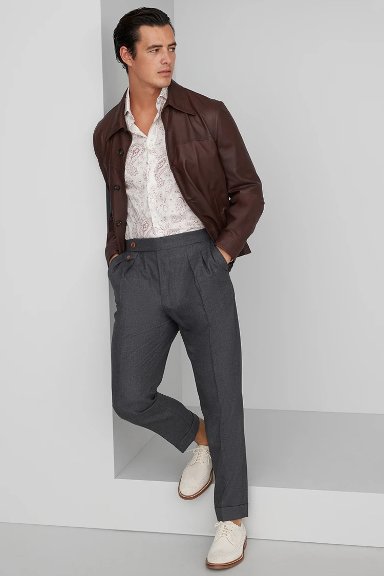 Brown leather jacket, white floral shirt, gray dress pants, and white longwing brogues outfit