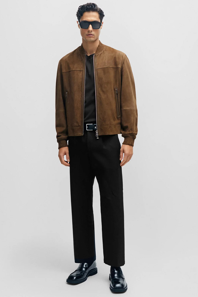 Brown suede jacket, v-neck black t shirt, black pants and black loafers outfit