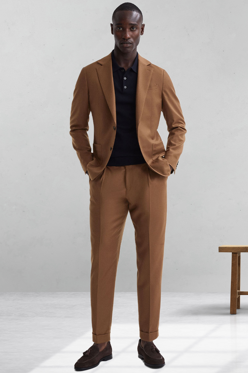 Brown suit, black polo t-shirt, and brown loafers outfit