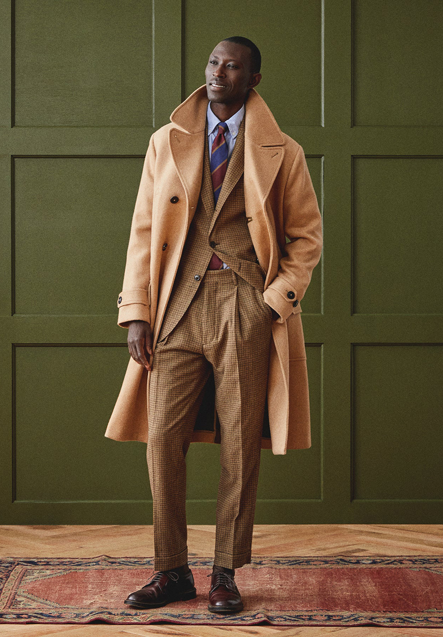 Brown suit, camel overcoat, brown tie, light blue dress shirt, and brown brogues outfit
