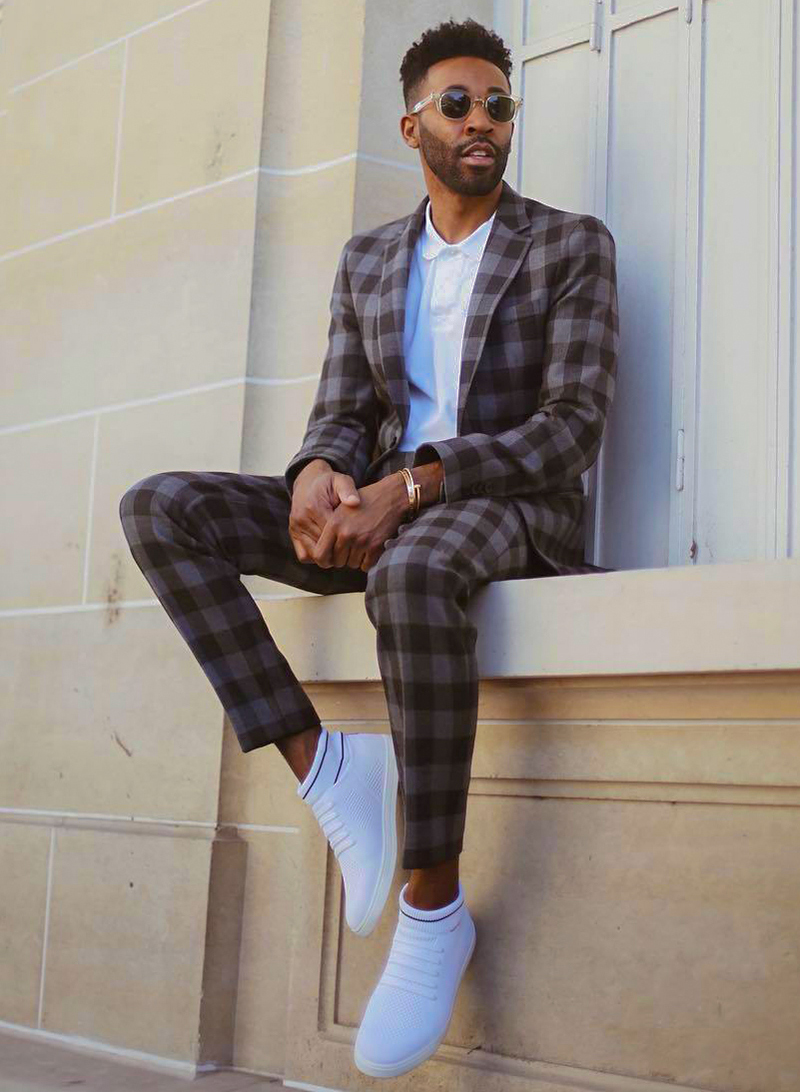 Brown suit, white polo, and low-top sneakers outfit