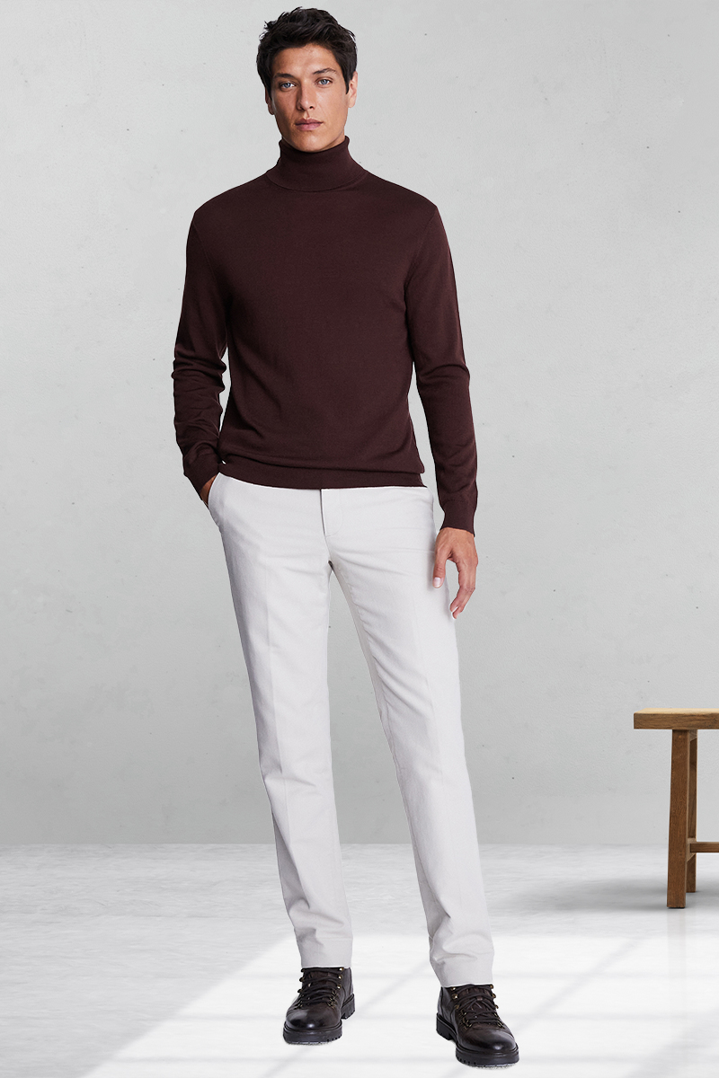 Burgundy turtleneck, white trousers, and brown hiking boots outfit