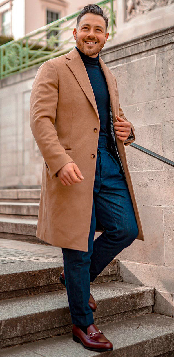 Camel overcoat, blue jeans, turtleneck, and horsebit loafers outfit