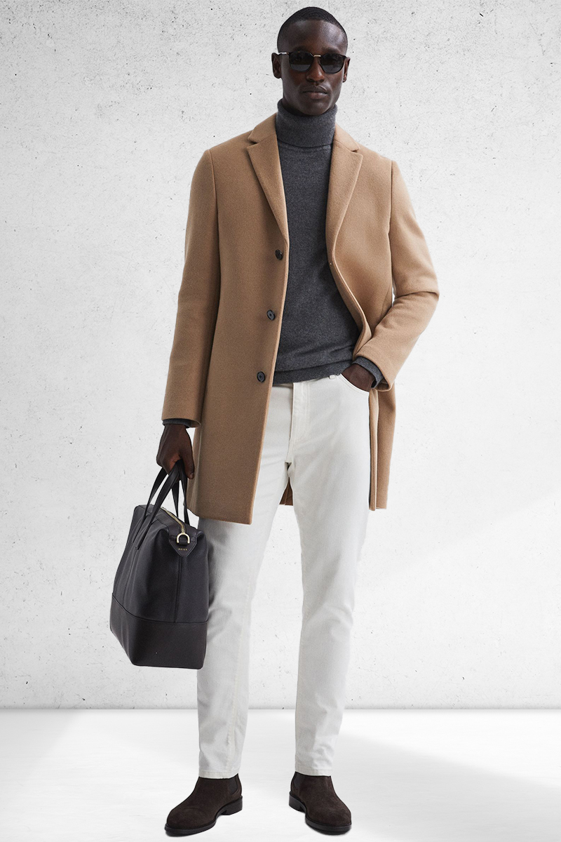 Camel overcoat, gray turtleneck, white jeans, and brown suede Chelsea boots outfit