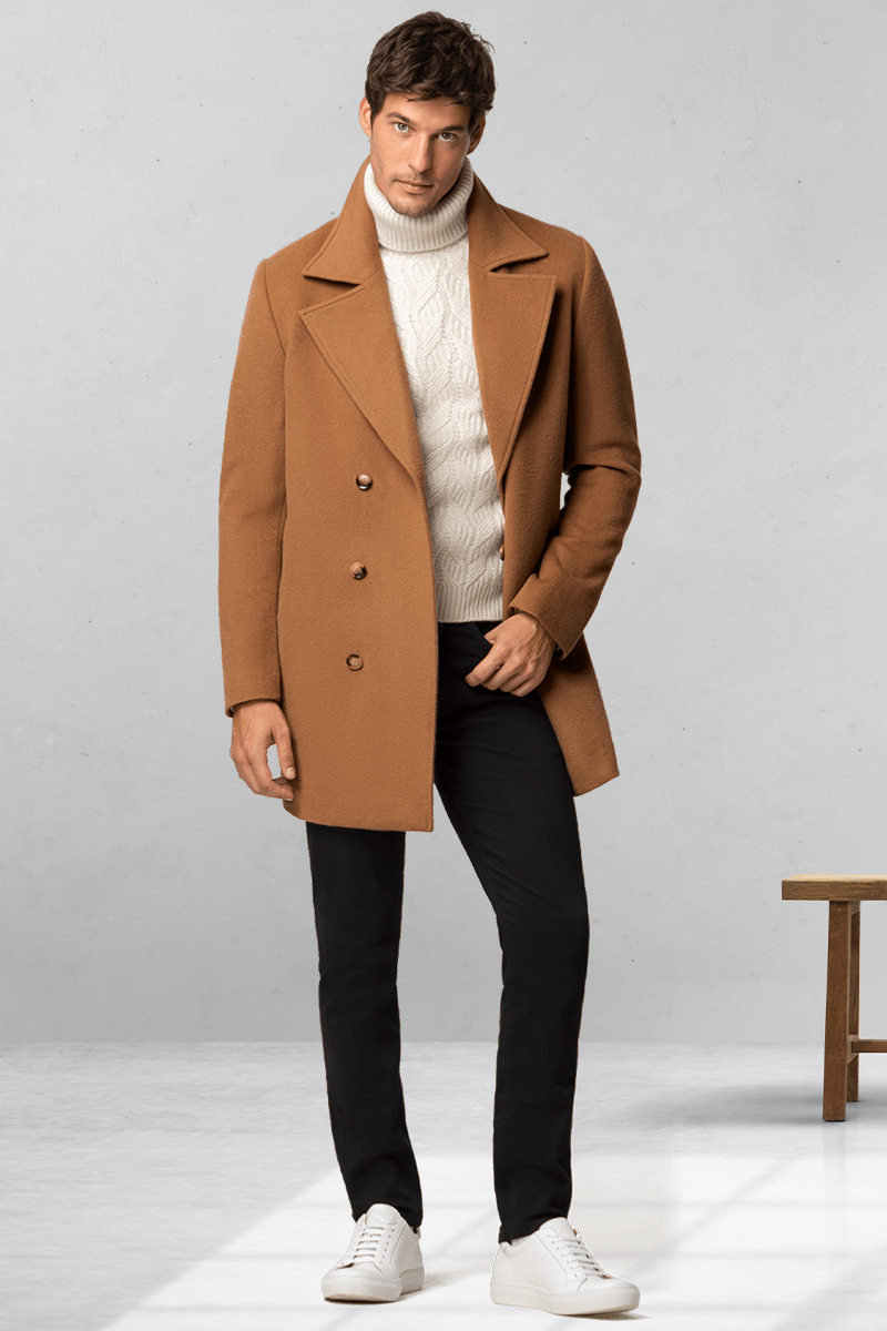 Camel pea coat, white turtleneck, black jeans, and white sneakers outfit