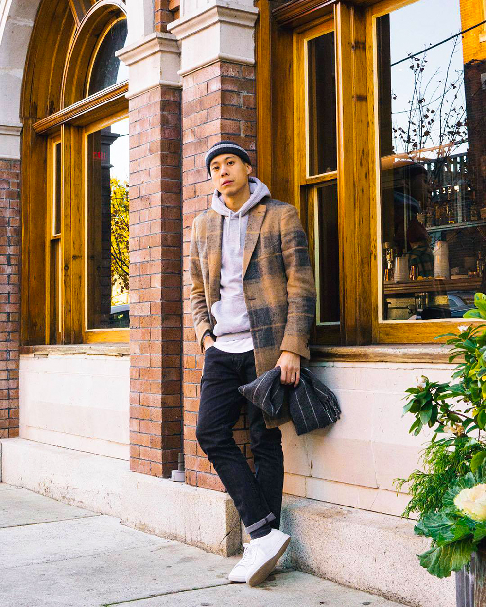 Camel plaid overcoat, gray hoodie, white crew neck t-shirt, black jeans, white low-top sneakers outfit