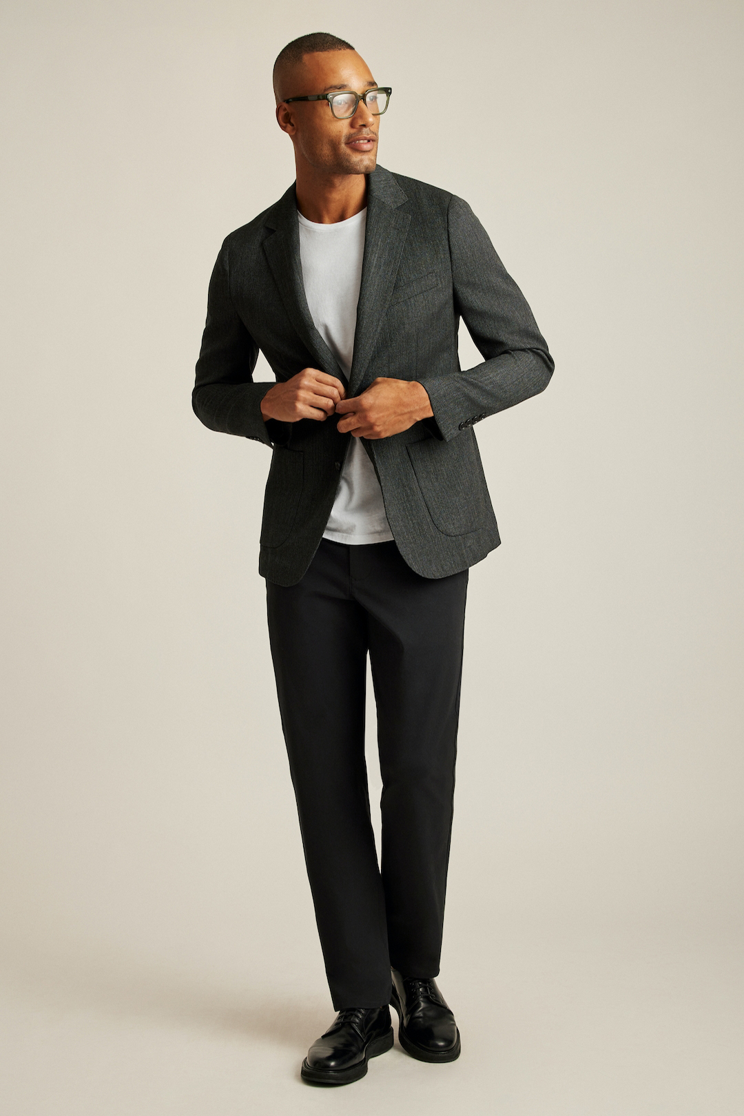 Charcoal gray blazer, white t-shirt, black pants, and black derby shoe outfit