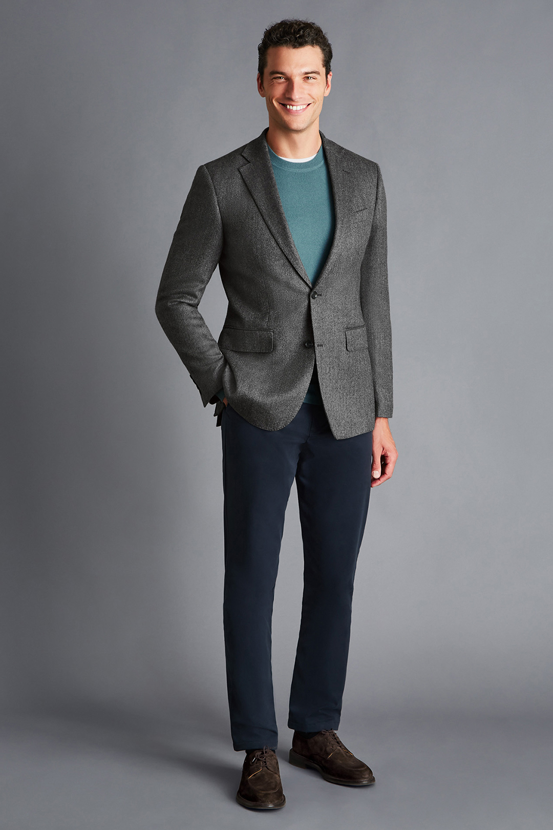 Gray blazer, blue sweater, navy pants, and brown suede derby shoes outfit