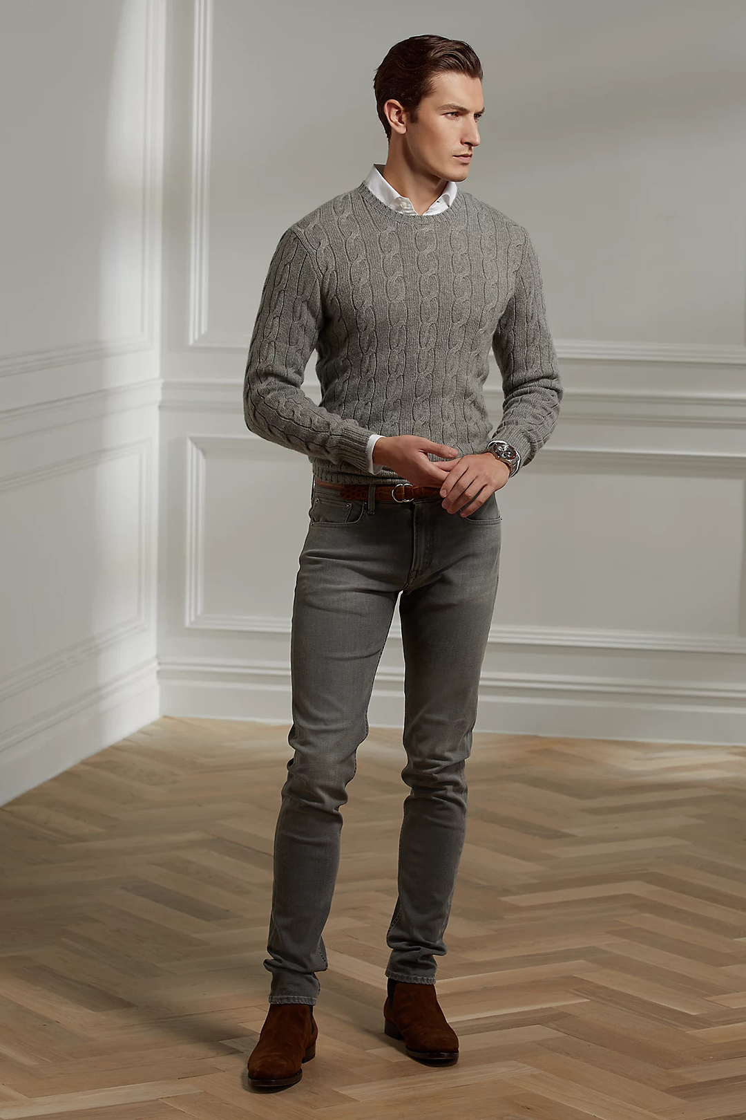 Gray cable knit sweater over white dress shirt, gray jeans, and brown suede Chelsea boots outfit