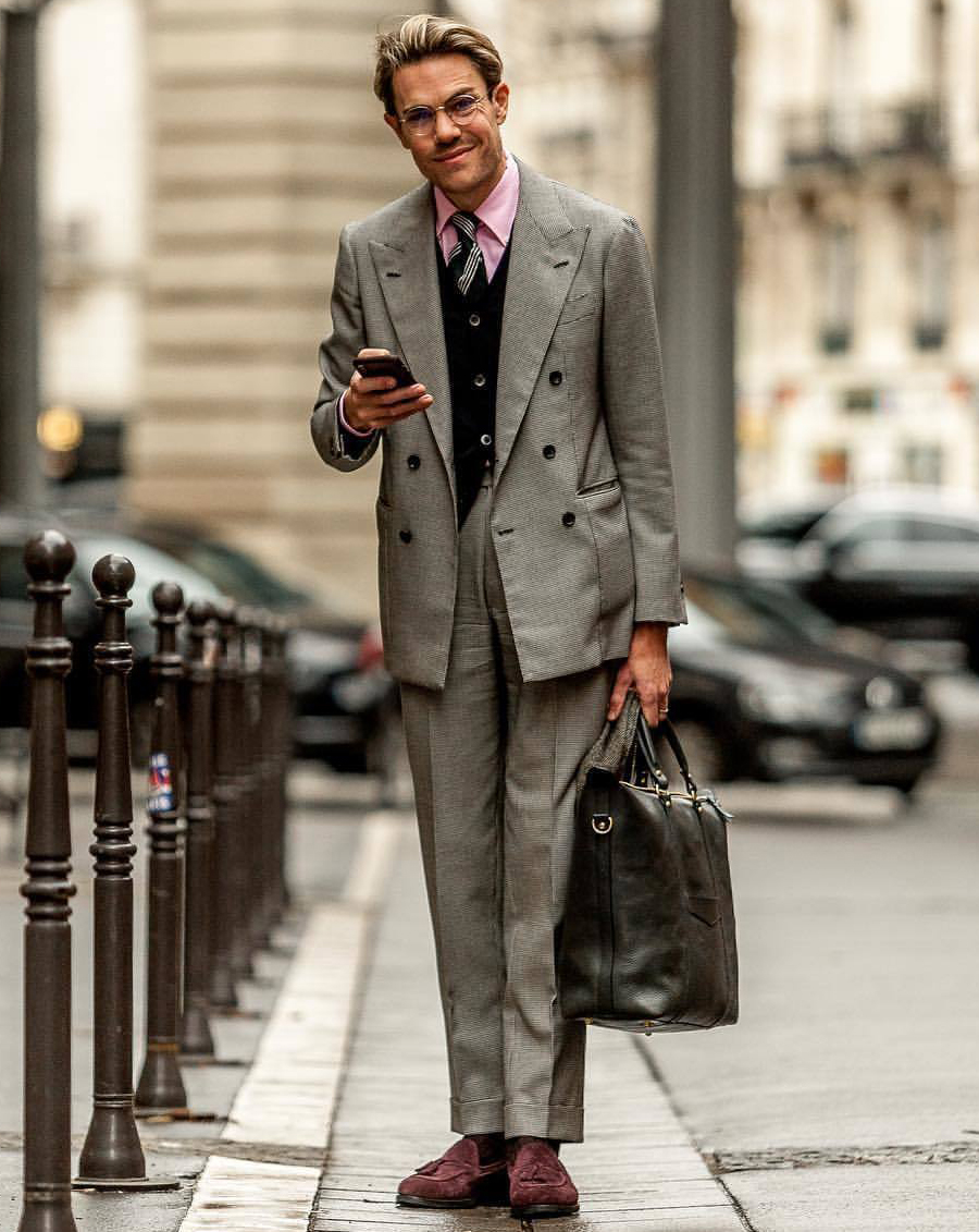 Gray double-breasted blazer, black cardigan, pink dress shirt, and burgundy loafers outfit