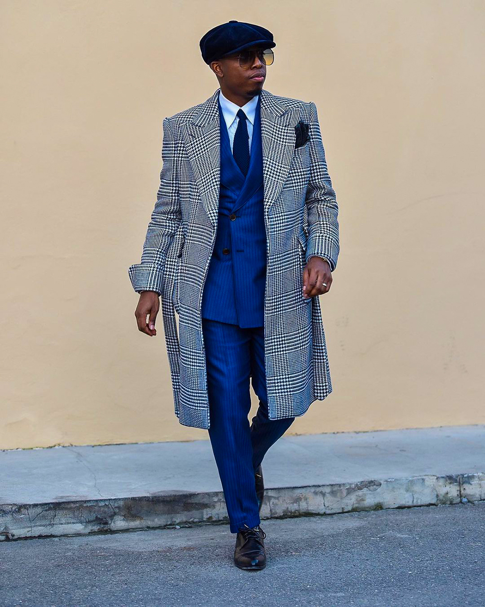 Gray herringbone overcoat, blue suit, white dress shirt, black derby shoes outfit