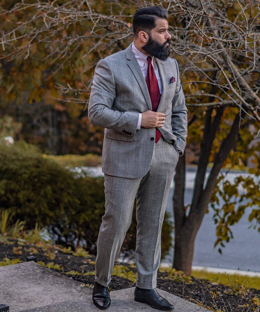 Gray plaid suit, pink dress shirt, and black Chelsea boots outfit