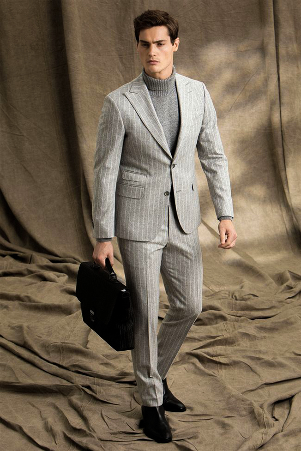 Gray suit, gray turtleneck, and black Chelsea boots outfit