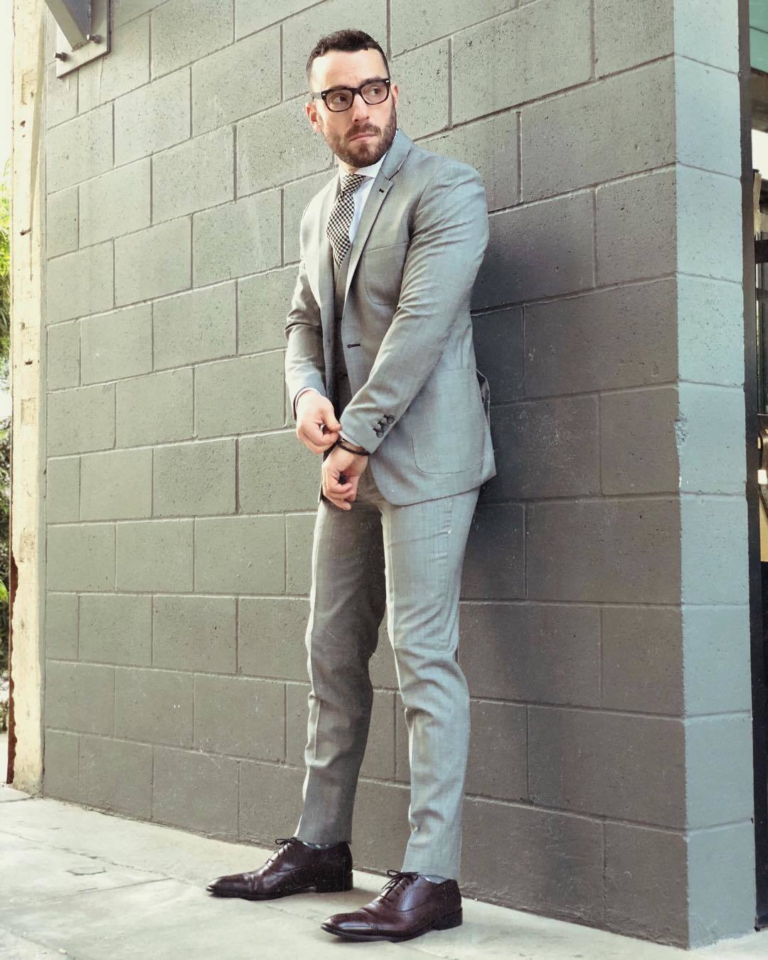 Gray three-piece suit, white dress shirt, and burgundy oxford shoes