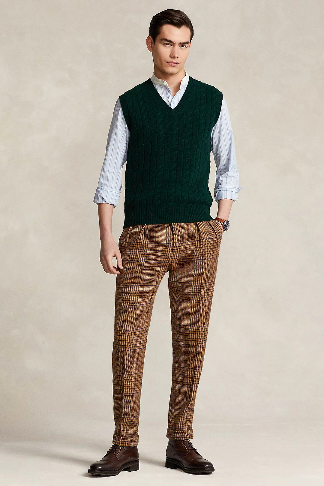 Green sweater vest, blue shirt, brown pants and dark brown dress boots outfit
