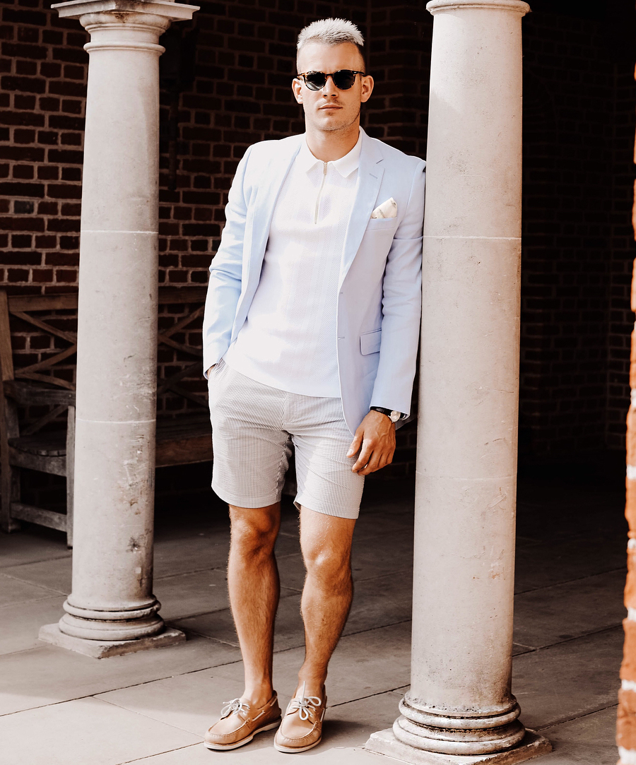 Light blue blazer, white polo, gray seersucker shorts, and tan leather boat shoes outfit