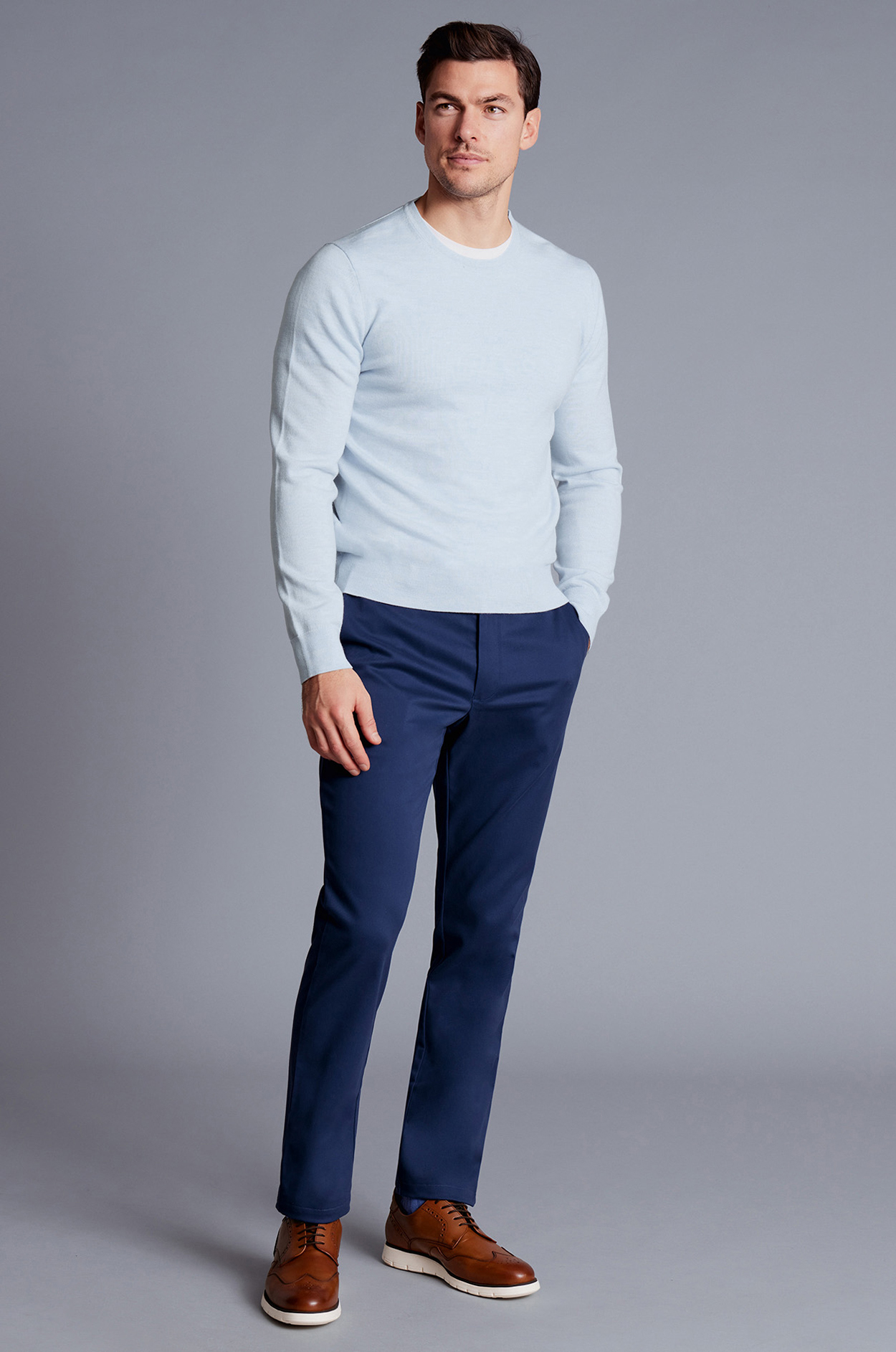 Light blue crew neck shirt, navy pants, and brown shoes outfit