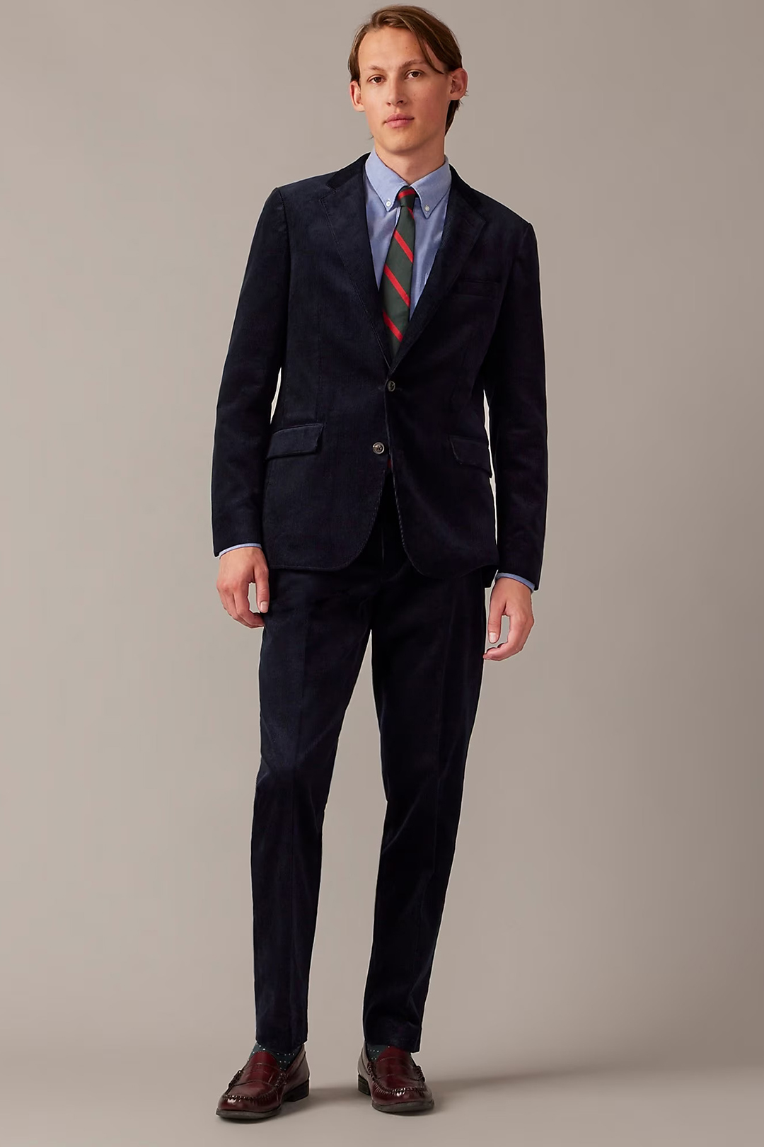 Navy corduroy suit, blue button-down shirt, green and red striped tie, and oxblood penny loafers outfit