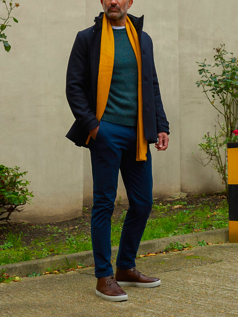 Navy overcoat, green crew neck jumper, navy chinos, brown leather sneakers outfit