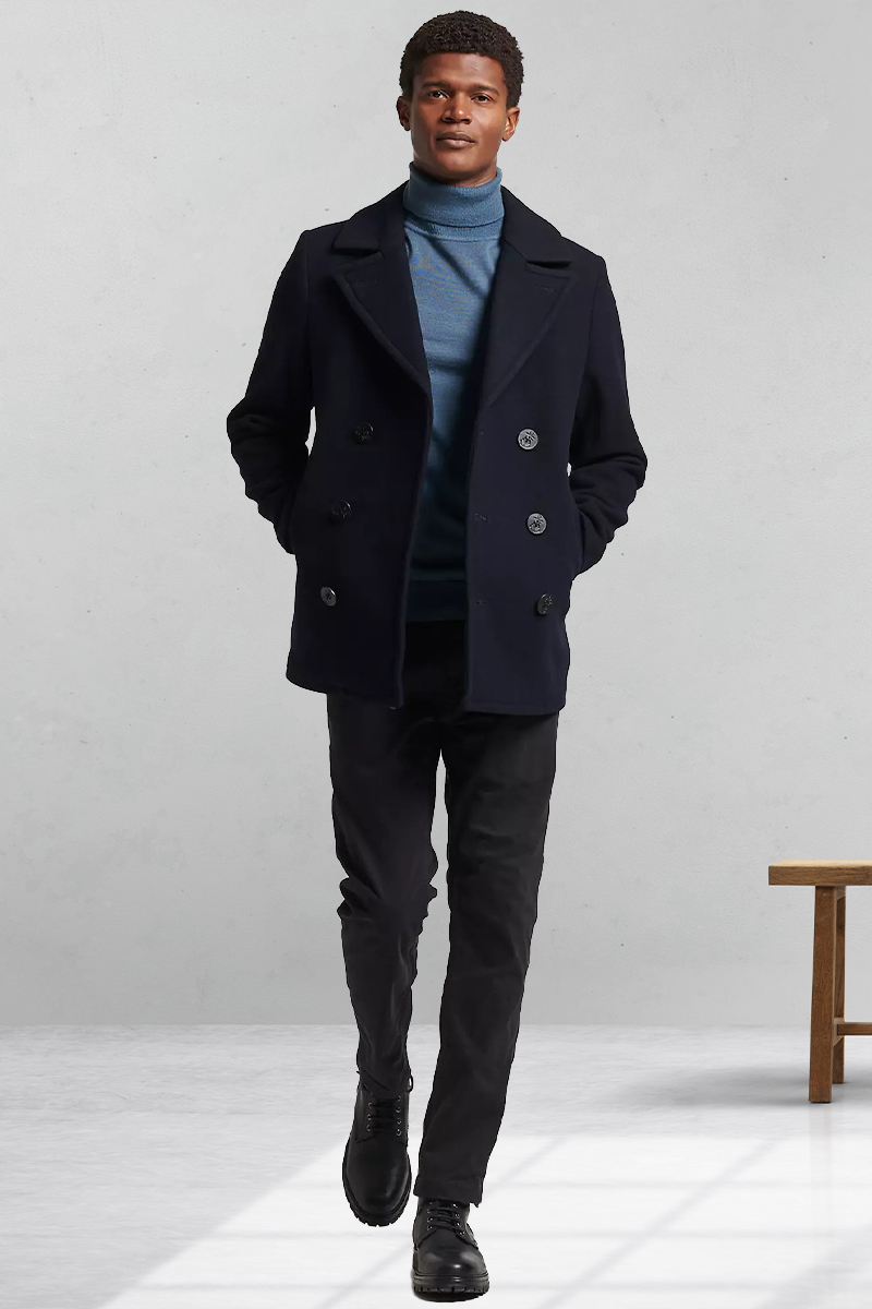 Navy pea coat, blue turtleneck, black chinos, and black chukka boots outfit