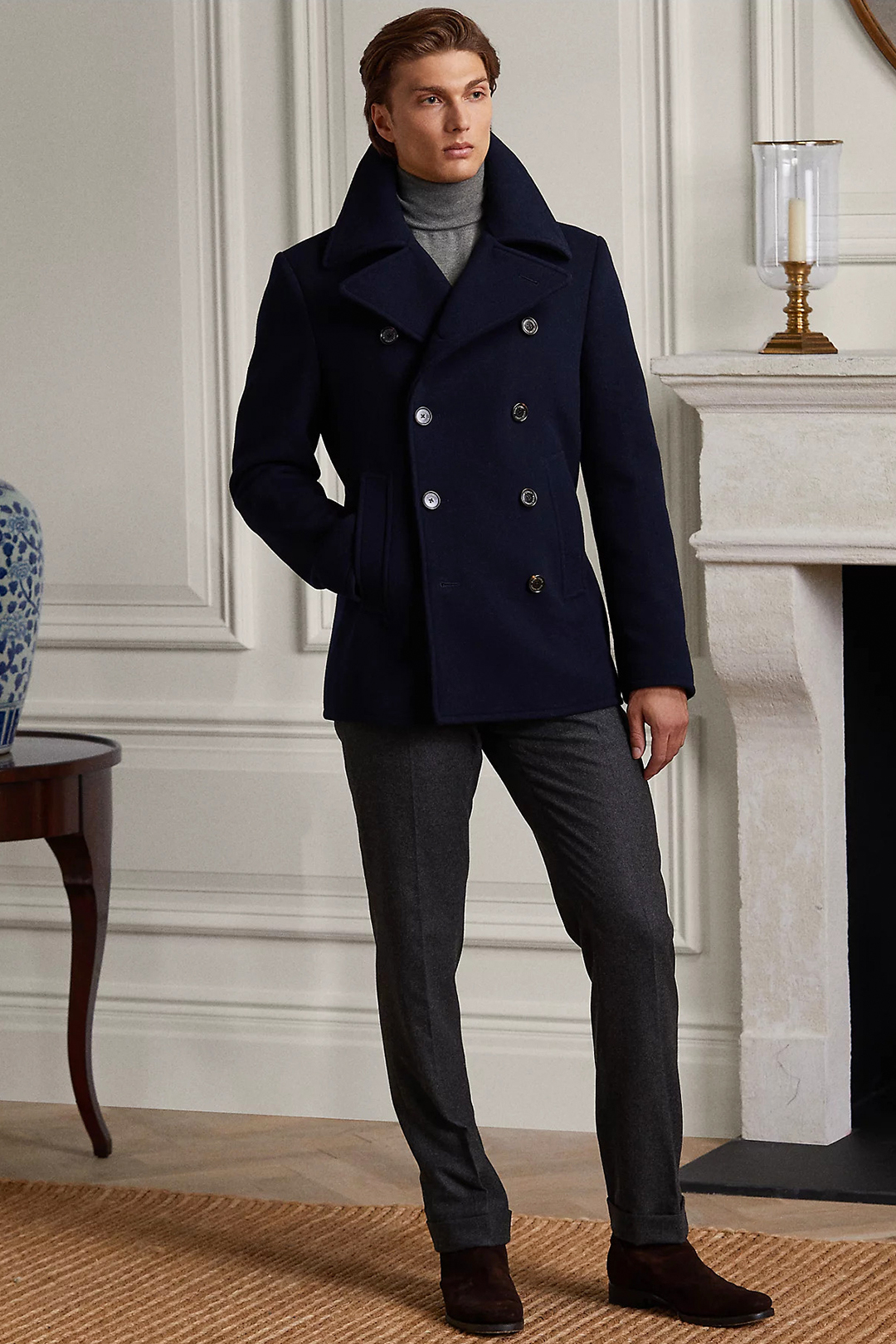 Navy pea coat, gray turtleneck, charcoal dress pants, and brown suede Chelsea boots outfit