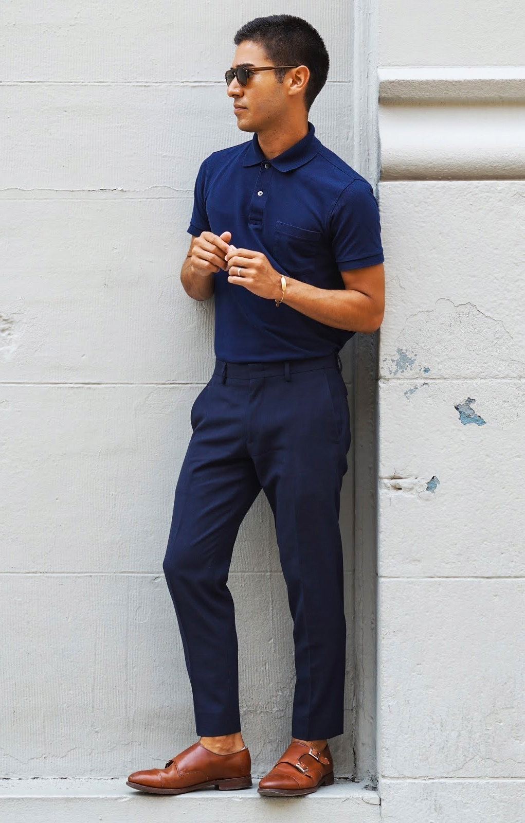 Navy polo shirt, navy blue pants, and brown leather double monks outfit
