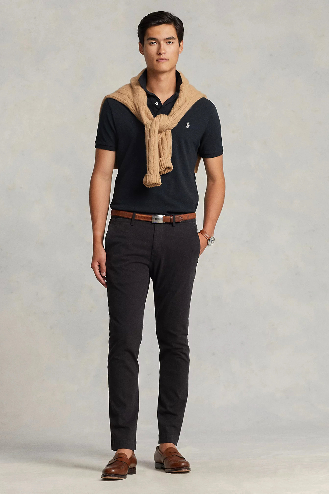 Navy polo t-shirt, tan sweater, black chinos, and brown loafers outfit