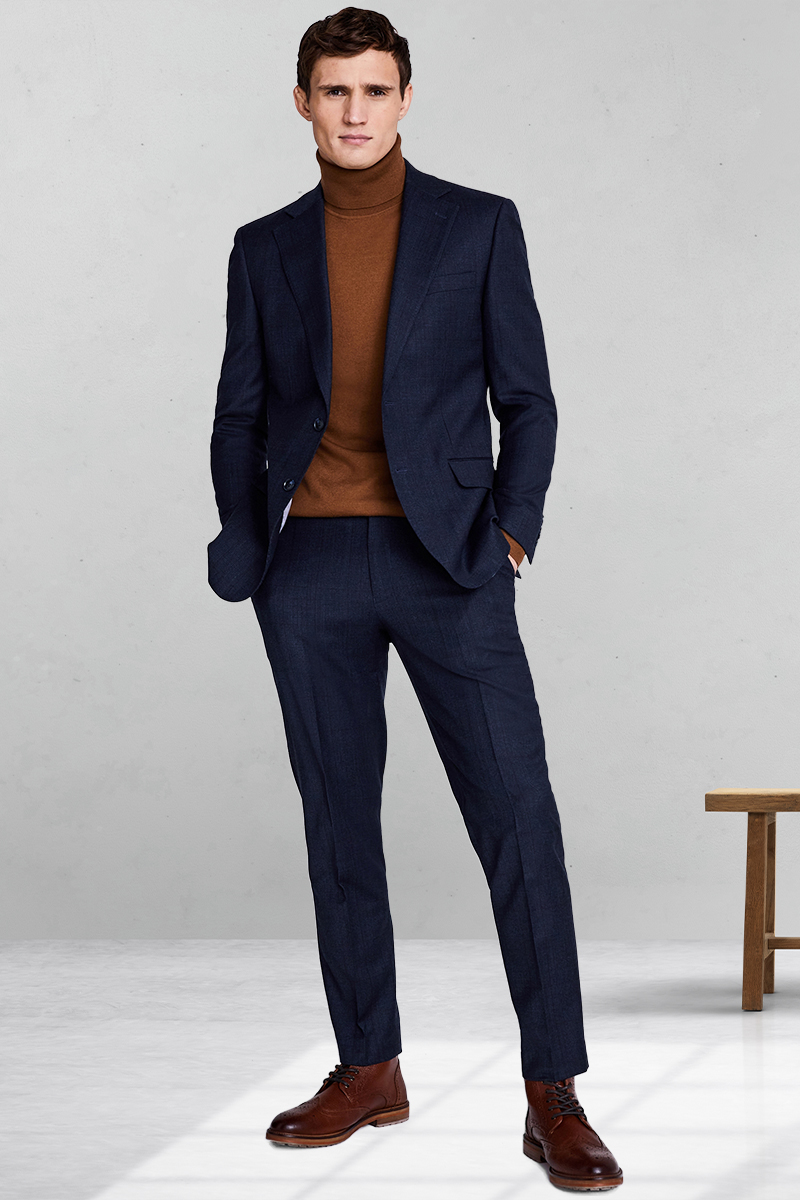 Navy suit, brown turtleneck, and dark brown brogued boots outfit