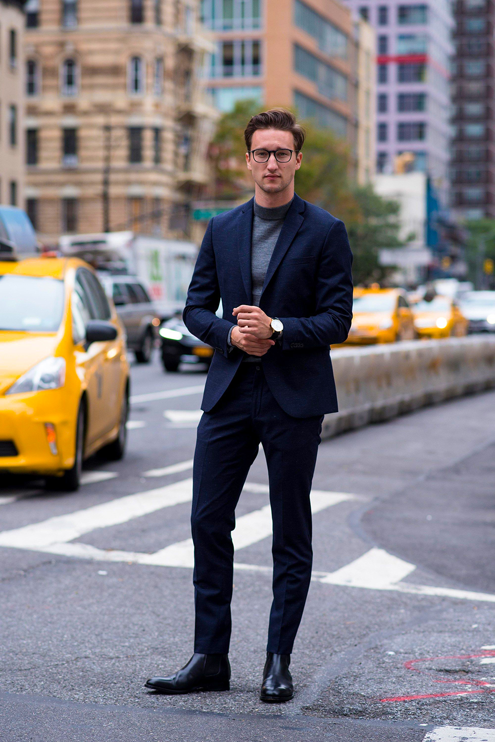Navy suit, charcoal turtleneck, and black Chelsea boots outfit