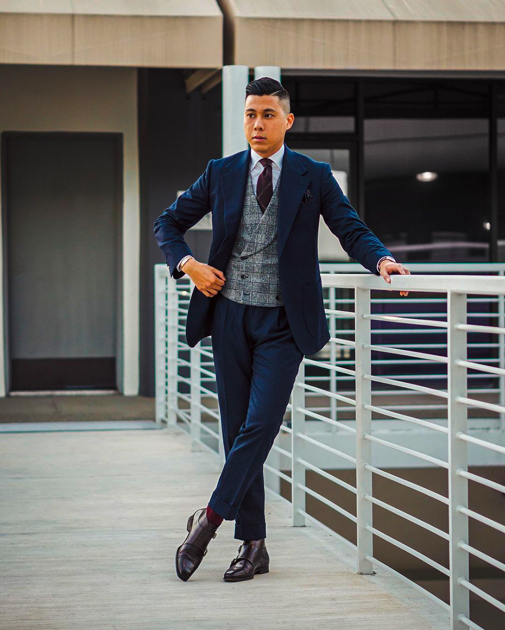 Navy suit, gray plaid waistcoat, dress shirt, and monks outfit