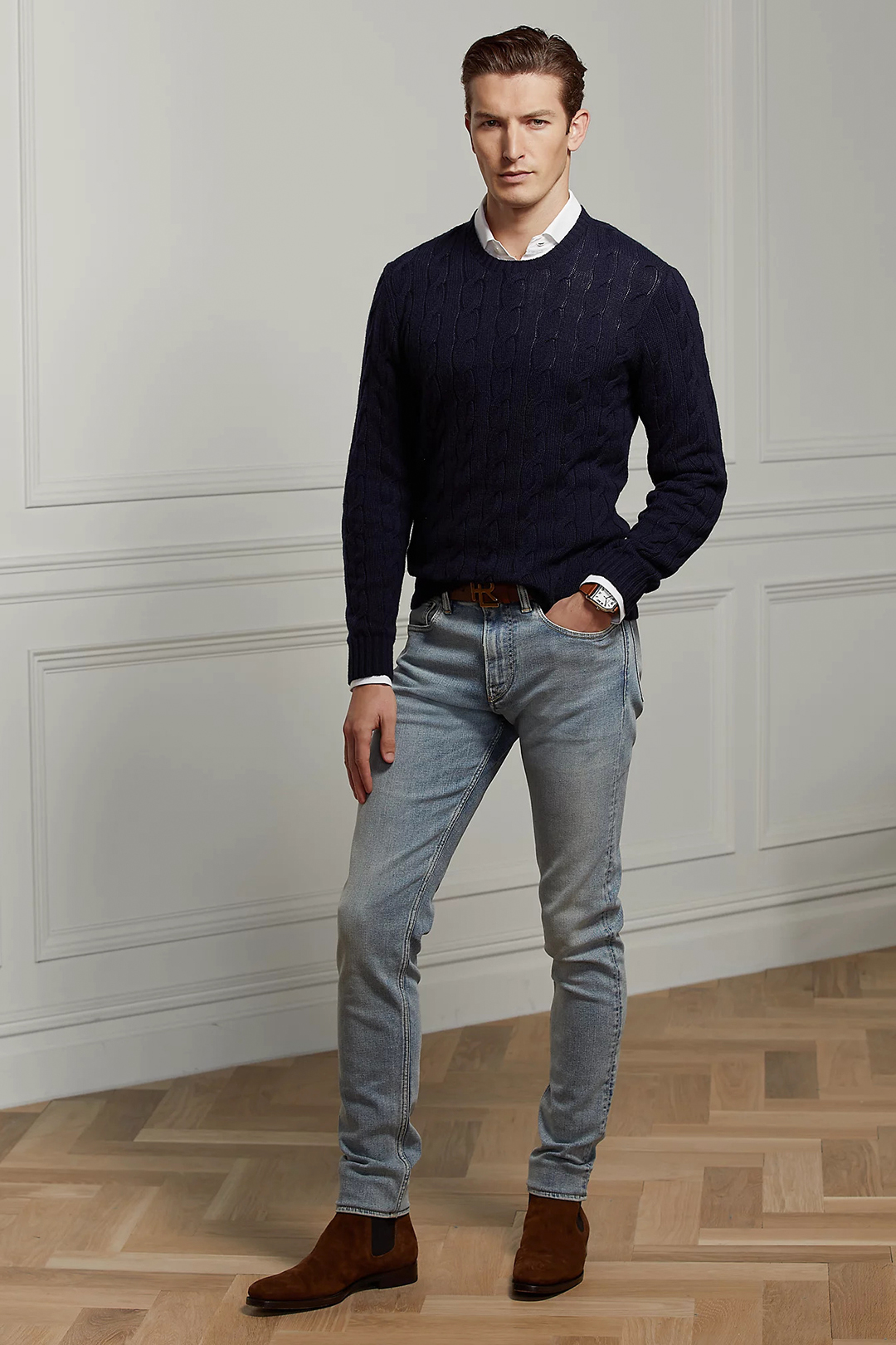 Navy sweater over white dress shirt, light blue denim jeans, and brown suede Chelsea boots outfit