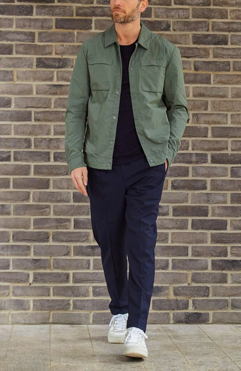 Olive overshirt, navy chinos, and trainers outfit