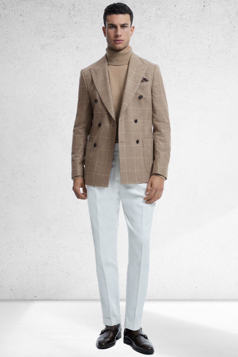 Tan check double-breasted blazer, tan turtleneck, white trousers, and dark brown double monk strap shoe outfit