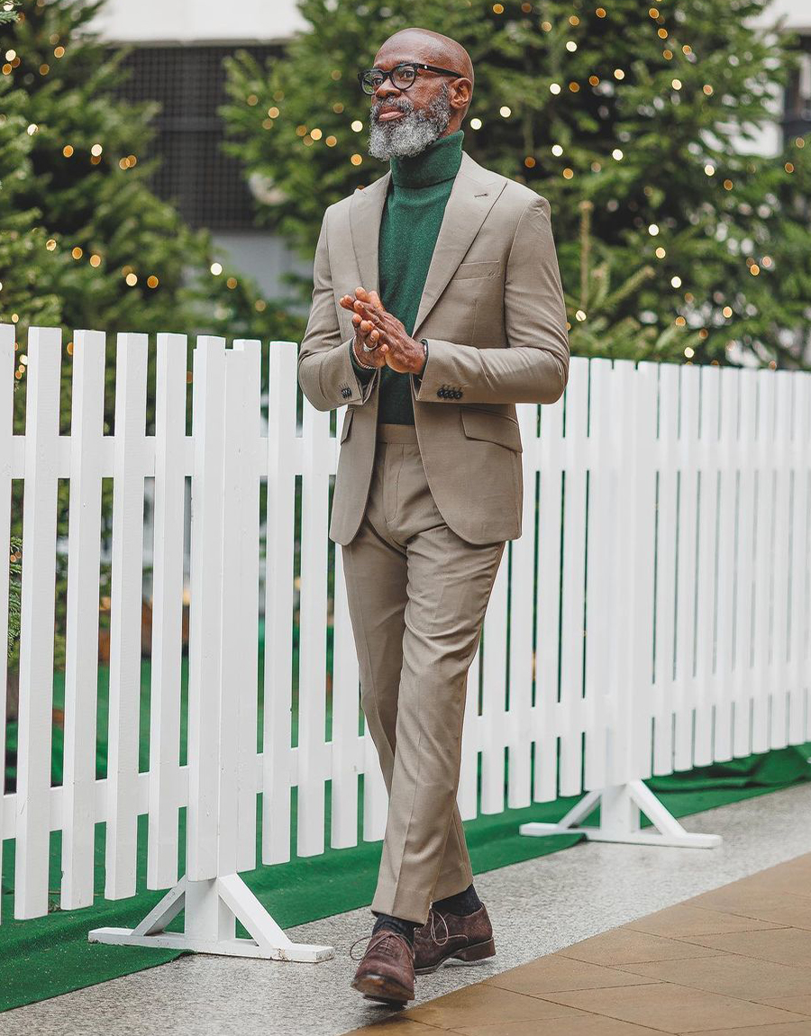 Tan suit, green turtleneck, and brown oxford shoes outfit
