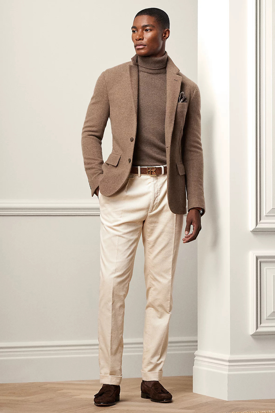 Taupe blazer, brown turtleneck, beige trousers, and brown suede loafers outfit