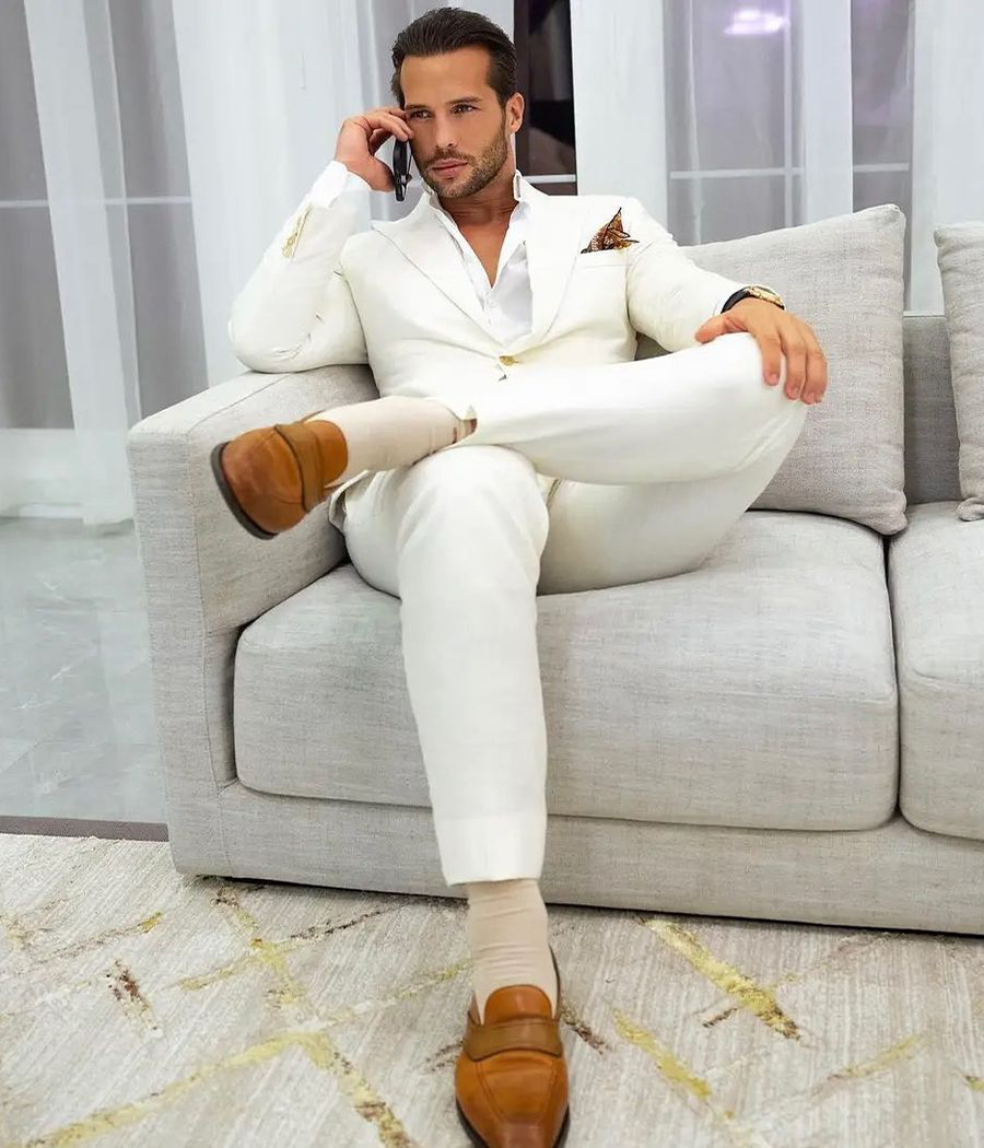 Tristan in ivory suit, white dress shirt, and brown loafers outfit