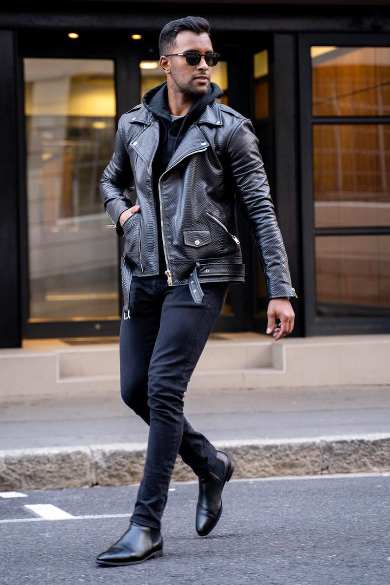 All-black outfit with biker jacket, hoodie, jeans, and Chelsea boots
