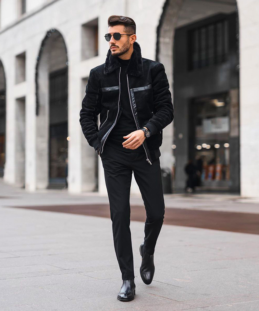 Wear a black shearling jacket, black turtleneck, black chinos, and black Chelsea boots