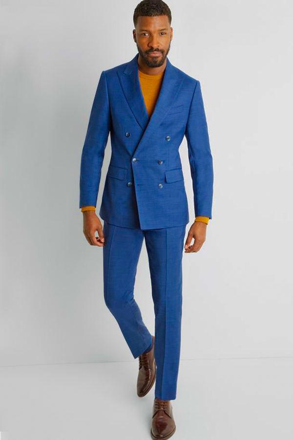 Wear a blue suit, tobacco crew neck sweater, and brown derby shoes