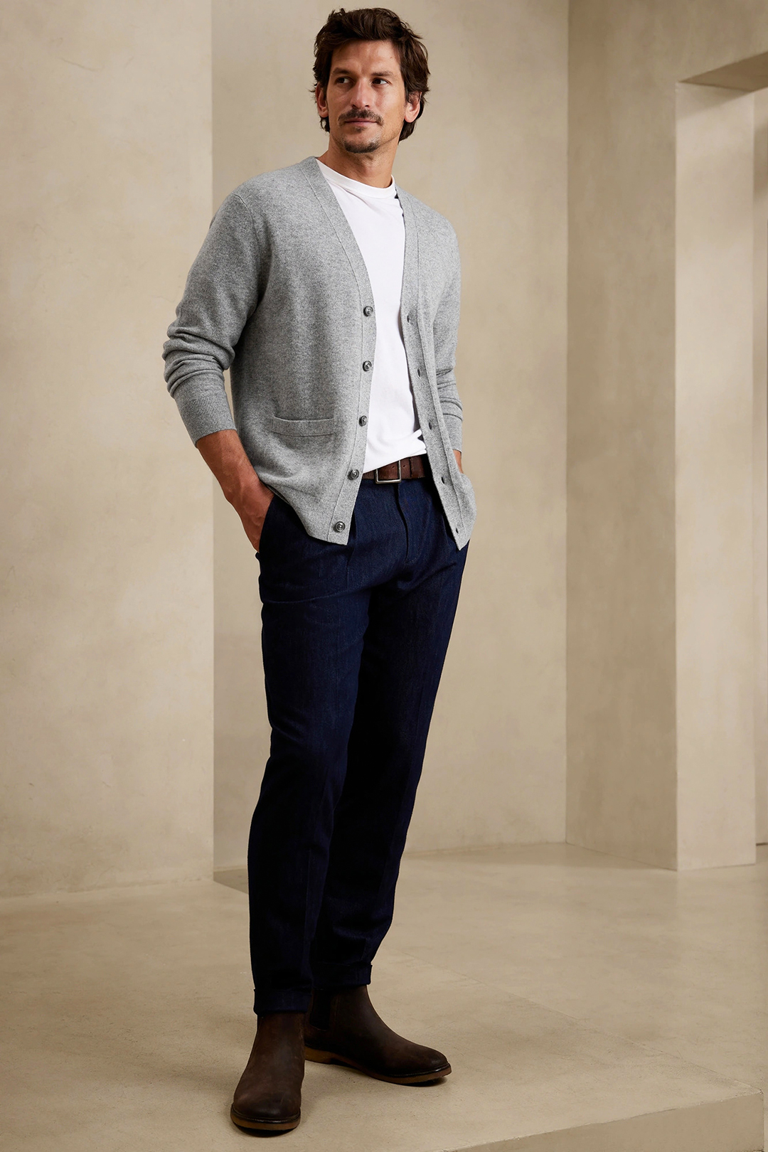 Wear a gray cardigan, white t-shirt, navy denim jeans, and brown Chelsea boots