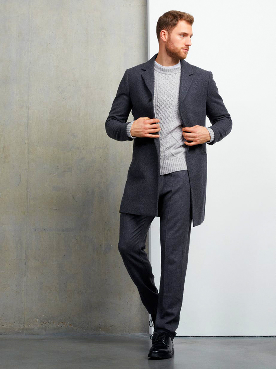 Gray overcoat, gray patterned jumper, white crew-neck t-shirt, gray dress pants, and black derby shoes outfit