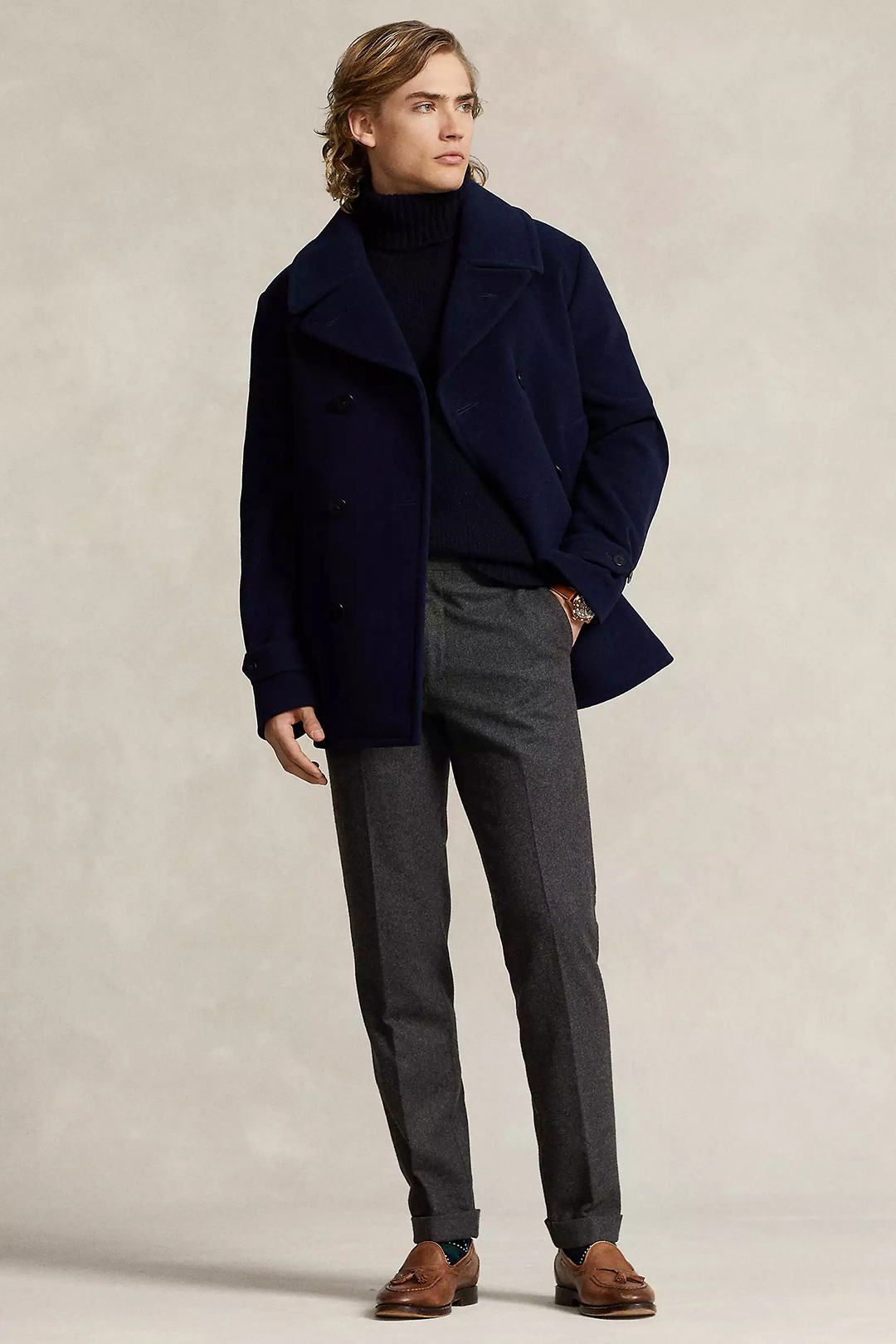 Wear a navy pea coat, navy turtleneck, charcoal dress pants, and brown leather loafers